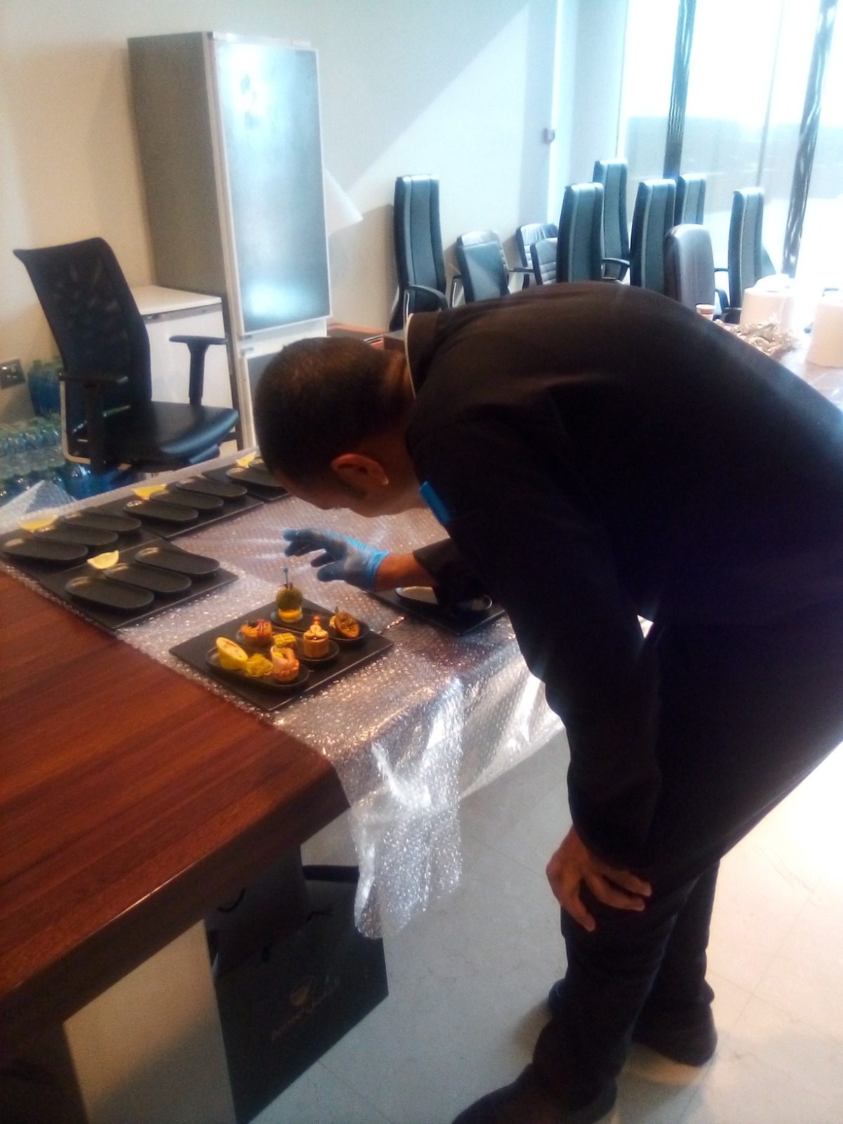 Chef plating canapés for a boardroom event